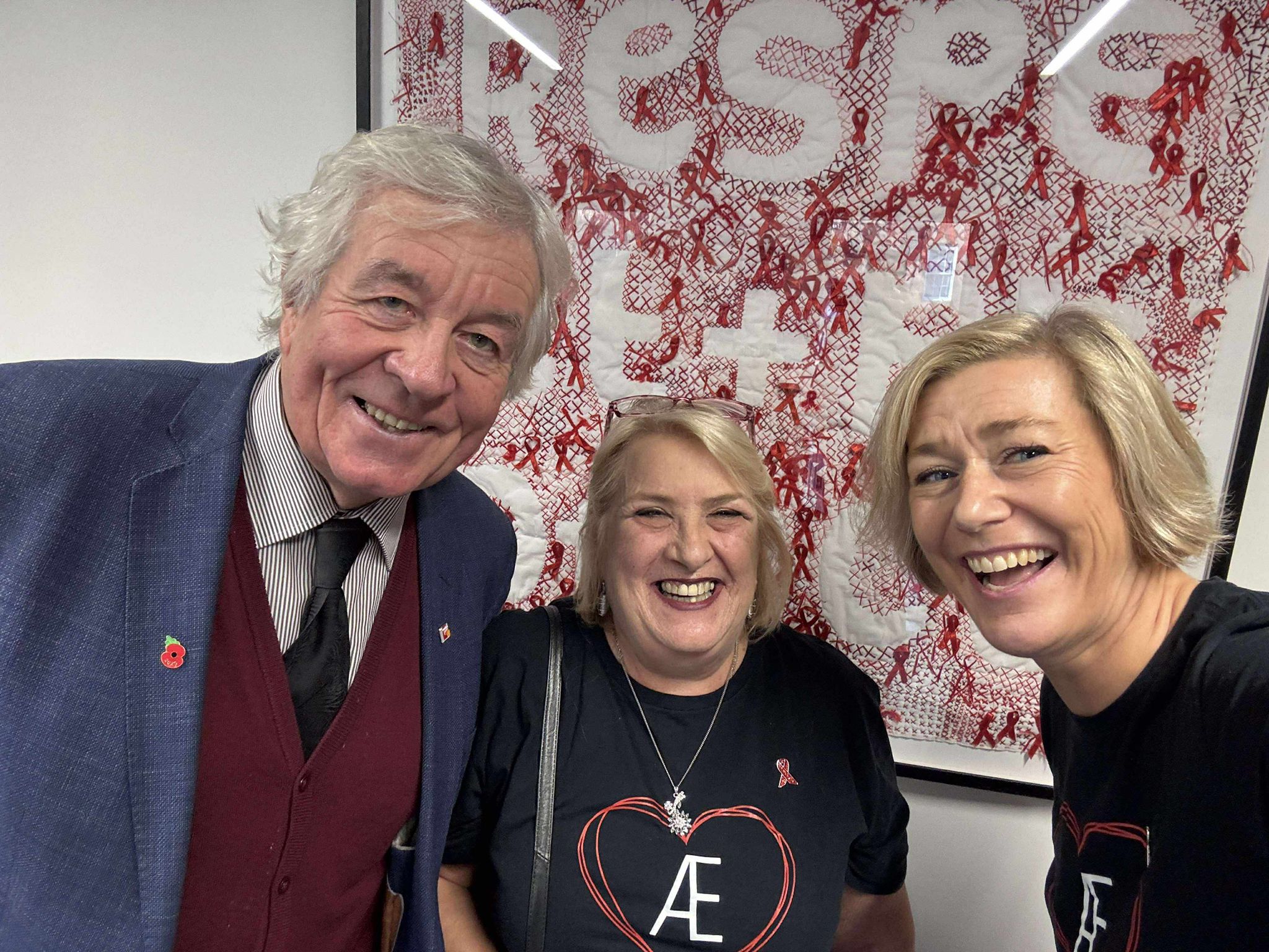 Three smiling individuals.