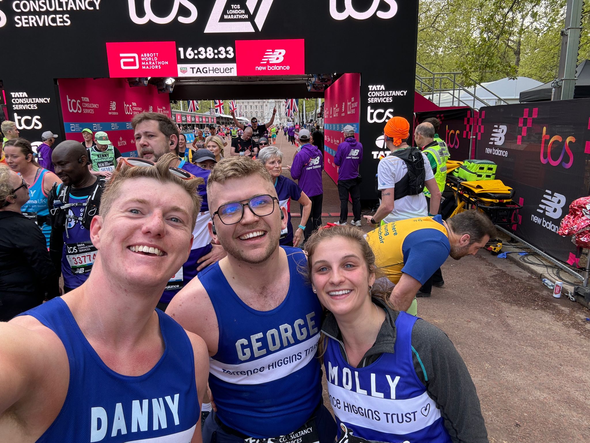 Three Terrence Higgins Trust marathon runners smiling for a selfie.