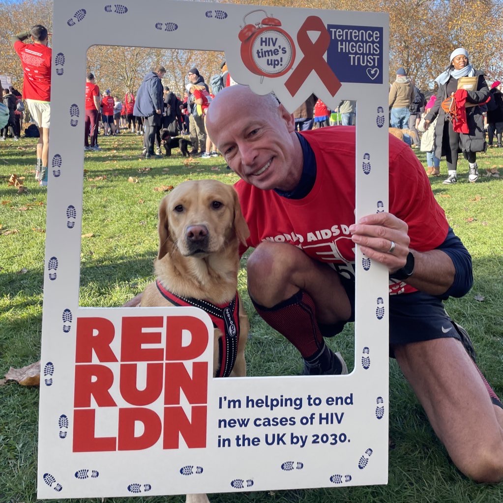 Runner with dog holding a large frame.