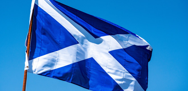 Flag of Scotland against a sky backdrop.