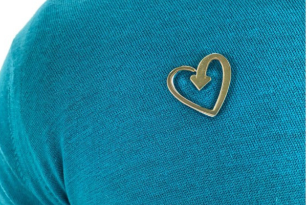 Gold heart badge on a teal jumper