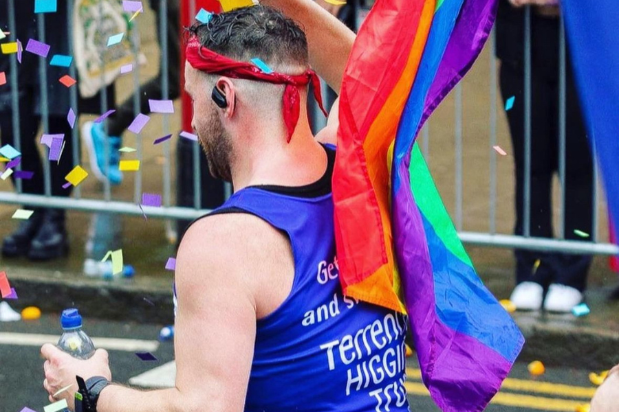 A Terrence Higgins Trust runner with a Pride flag.