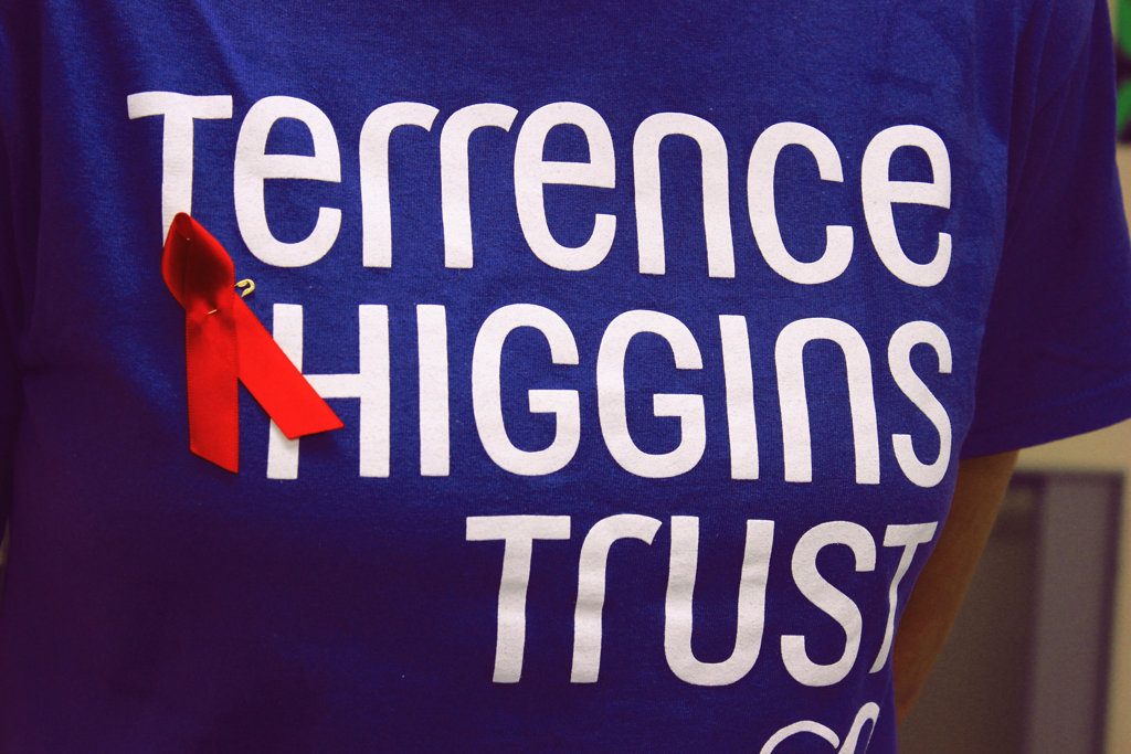 A blue Terrence Higgins T-shirt with a red ribbon for World AIDS Day.