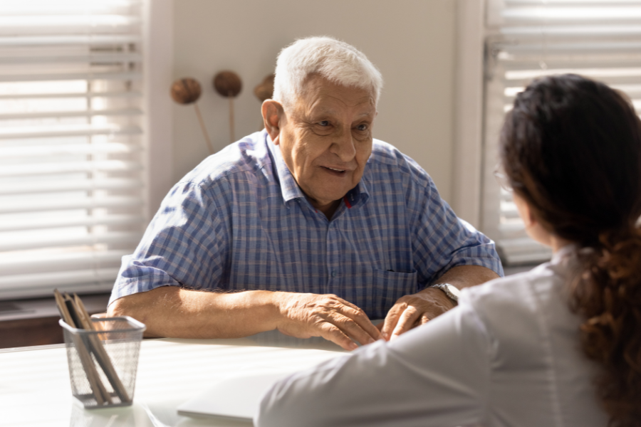 An older man talks to a doctor