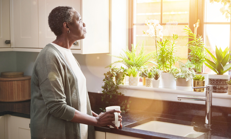 Woman standing at sink Woman standing at sink