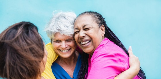 Three people laughing together