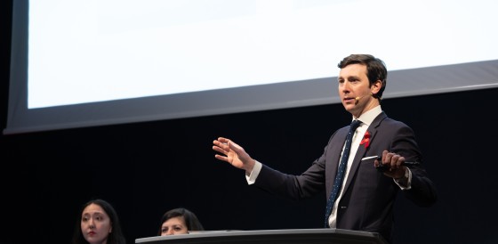 A man speaking at the Terrence Higgins Trust auction.