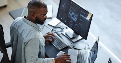 Man on computer analysing data.