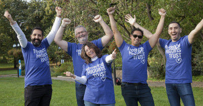 Group posing in THT shirts in a park