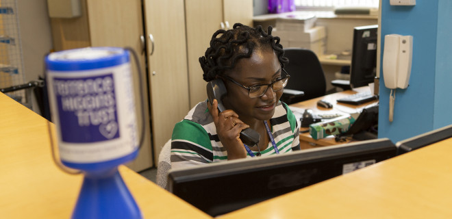 Volunteer on the phone in Terrence Higgins Trust reception