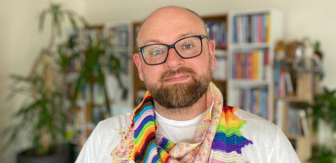 Martyn with a knitted Pride themed scarf.