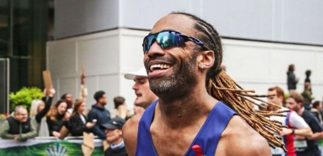 A smiling Terrence Higgins Trust marathon runner.