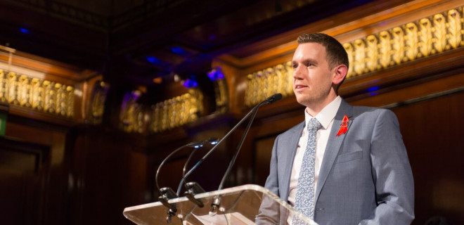 Man making a speech at a lectern