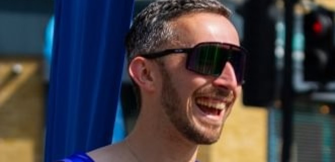 A Terrence Higgins Trust supporter at the 2026 London Marathon with sunglasses.