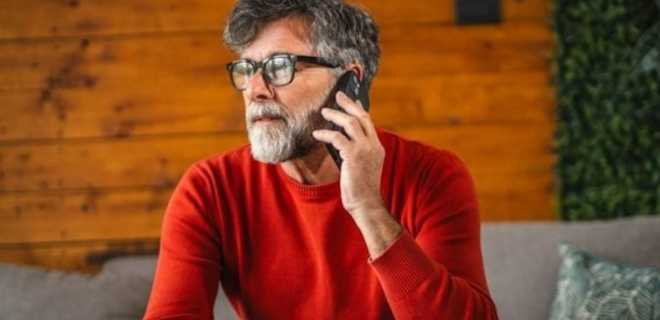 A man talks on his phone.