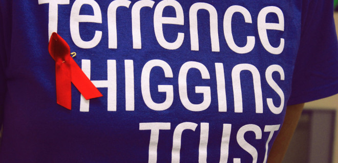 A blue Terrence Higgins T-shirt with a red ribbon for World AIDS Day.