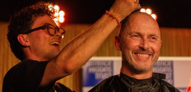 A Terrence Higgins Trust supporter have their head shaved on stage at the Royal Vauxhall Tavern.