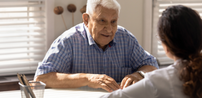 An older man talks to a doctor