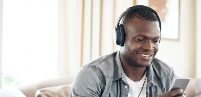 Man with headphones looking at his mobile phone