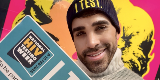 Dr Ranj holds an 'I Test' sign for National HIV Testing Week