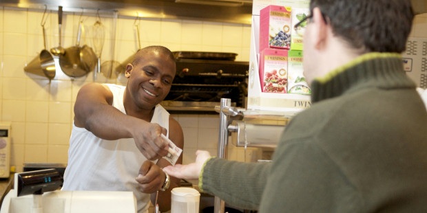 Shop worker handing over change