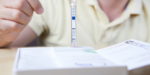The buffer bottle of a HIV test kit standing.