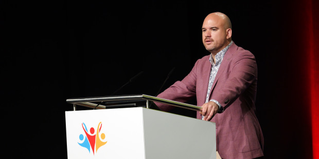 Richard Angell delivers a speech at the International AIDS Conference.