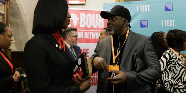 A conversation between two individuals at a Terry Higgins Trust event.