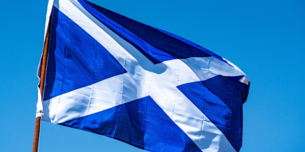 Flag of Scotland against a sky backdrop.