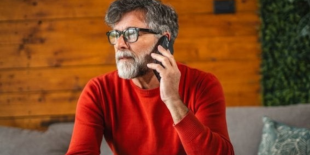 A man talks on his phone.