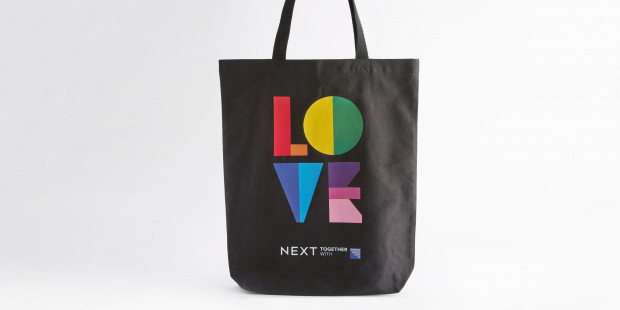 Tote bag with love written on it in pride flag colours