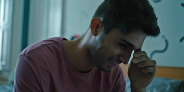 Man crying, with the text "stigma is more harmful than HIV"