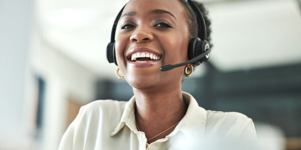 Stock image of a smiling call handler.
