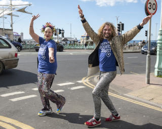 Two people walking in fancy dress and celebrating