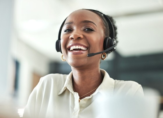 Stock image of a smiling call handler.